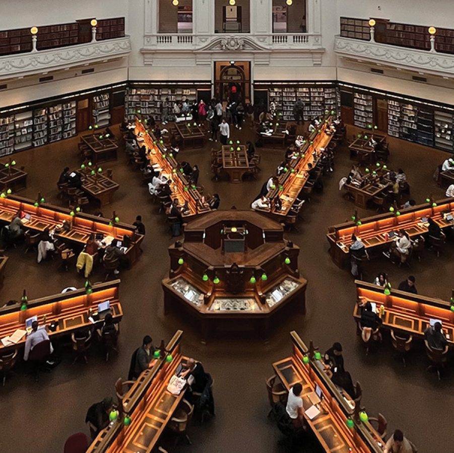 A top view of the large octagonal reading room inside the State Library Victoria in Melbourne, Australia .